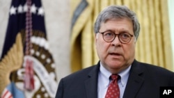 Attorney General William Barr participates in a law enforcement briefing on the MS-13 gang with President Donald Trump in the Oval Office of the White House, Wednesday, July 15, 2020, in Washington. (AP Photo/Patrick Semansky)