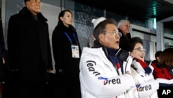 South Korean President Moon Jae-in, stands alongside first lady Kim Jung-sook as the South Korean national anthem is played at the opening ceremony of the 2018 Winter Olympics in Pyeongchang, South Korea, Feb. 9, 2018.