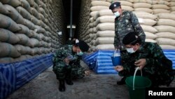 Soldiers check rice stocks at a warehouse in Ayutthaya province, north of Bangkok, Thailand, July 3, 2014. 