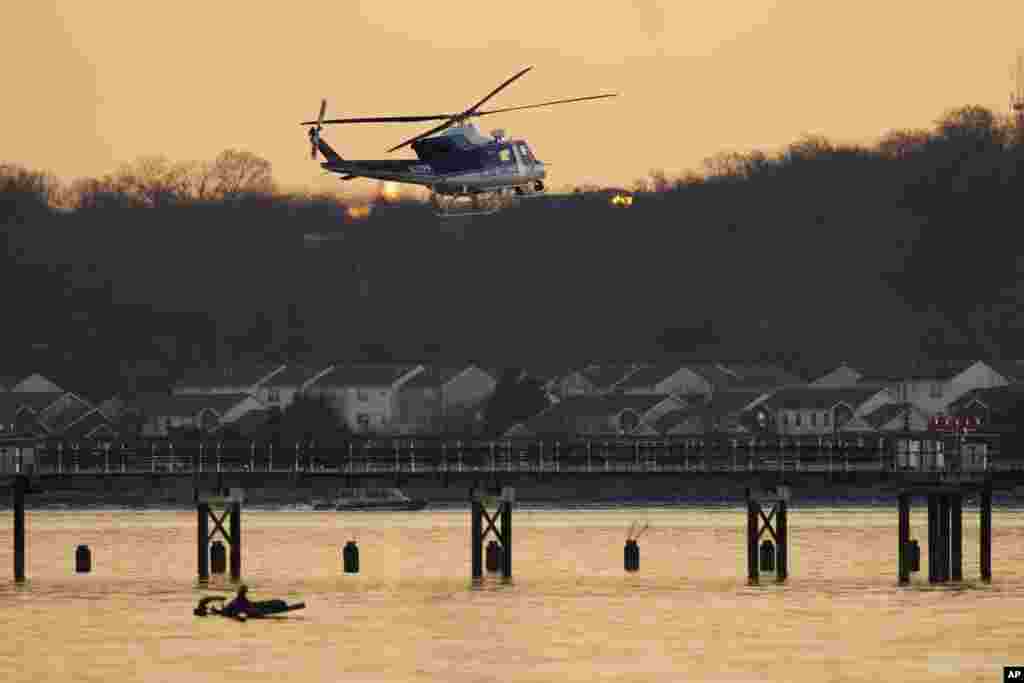 A U.S. Park Police helicopter flies over the Potomac River near Ronald Reagan Washington National Airport, Jan. 30, 2025, in Arlington.