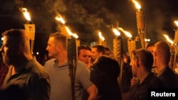 White supremacists carry torches on the grounds of the University of Virginia, on the eve of a planned "Unite the Right" rally in Charlottesville, Virginia, Aug. 11, 2017. (Alejandro Alvarez/News2Share via REUTERS)