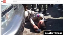 Chhean Pisith, a border police officer, was recorded collapsing in front of a car owned by Din Puthy, a local Cambodia National Rescue Party official in Poipet (Courtesy of YouTube.com). 
