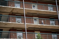 A student stands on the balcony of Ehringhaus dormitory on campus at the University of North Carolina in Chapel Hill, N.C., Aug. 18, 2020.