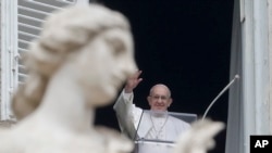 El papa Francisco saluda desde la ventana de su estudio a los peregrinos reunidos en la Plaza de San Pedro, en Roma, el domingo 20 de enero de 2019, para la oración del Angelus al mediodía.