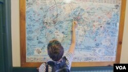 An Austrian tourist marks her path on a map in Williams, Arizona