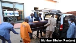 South Africa undertakers load a casket on a hearse