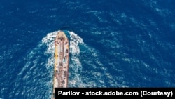 Oil chemical tanker sails blue sea. Aerial top view
