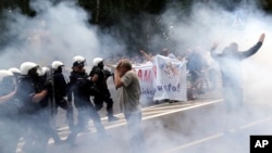 Police use tear gas against a group of young men trying to block the first LGBT pride parade in the eastern Polish city of Bialystok, July 20, 2019. 