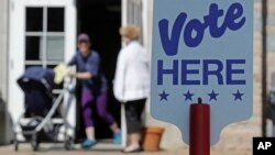 FILE - Voters leave a polling station in Charlotte, North Carolina, May 8, 2018.
