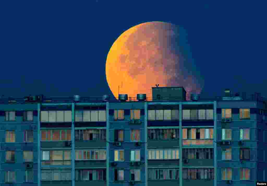 A partial lunar eclipse is seen over the residential building in Moscow, Russia.
