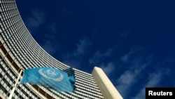 FILE - The flag of the International Atomic Energy Agency (IAEA) flies in front of its headquarters in Vienna, Austria.