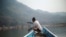 FILE - A local villager travels by boat where the future site of the Luang Prabang dam will be on the Mekong River, outskirt of Luang Prabang province, Laos, Feb. 5, 2020.