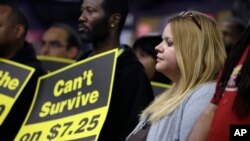 FILE - Amy Jennewein participates in a rally in support of raising the minimum wage University City, Mo. 