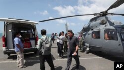Medical officers prepare a sample for loading on to a helicopter for testing in Sihanoukville, Cambodia, Thursday, Feb. 13, 2020. The Westerdam cruise ship, turned away by four Asian and Pacific governments due to virus fears, anchored Thursday off…