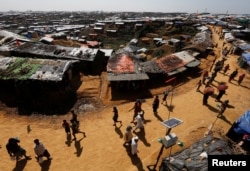 FILE - Rohingya refugees walk through the Kutupalong refugee camp area, near Cox’s Bazar, Bangladesh, Nov. 6, 2017.