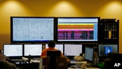 In this Nov. 16, 2015 photo, engineers in a control room monitor the status of the Mississippi Power Co. carbon capture power plant in DeKalb, Mississippi.