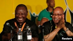 FILE: South Africa's President Jacob Zuma, right, jokes with his deputy, Cyril Ramaphosa, after Zuma's re-election in 2012. The ruling African National Party has delayed an inquiry into Zuma's spending.