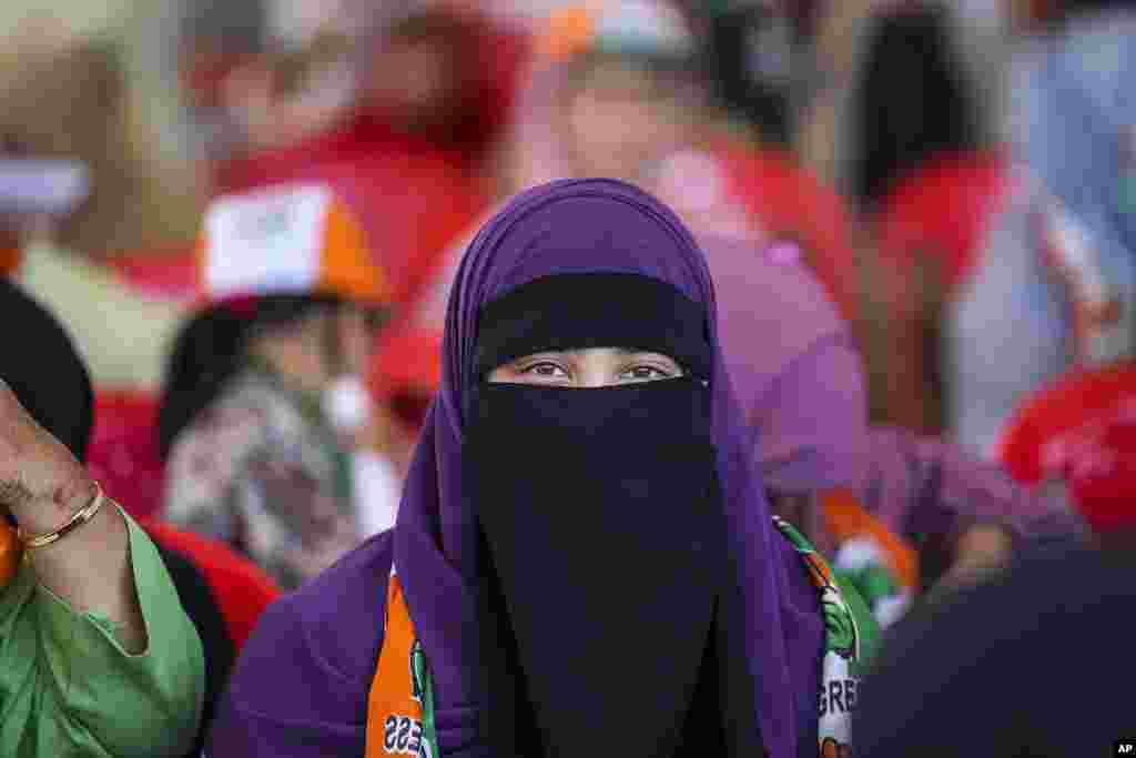 A Muslim veiled supporter of India's opposition Congress party looks on during an election rally on the outskirts of Srinagar, Indian controlled Kashmir.