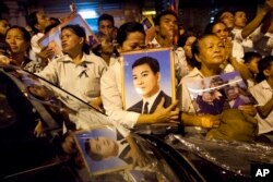 FILE - Cambodian mourners cry and pray outside a crematorium as the late King Norodom Sihanouk is cremated in Phnom Penh, Cambodia, Monday, Feb. 4, 2013.