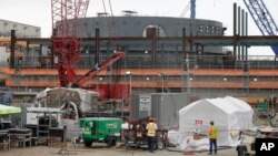 A containment building for unit two of the V.C. Summer Nuclear Station near Jenkinsville, S.C., is shown during a media tour of the facility Sept. 21, 2016. Construction of the nuclear power plant was halted on July 31, 2017 after $9 billion. (AP Photo/Chuck Burton/File photo) 