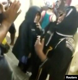 Men talk to two women who entered the Sabarimala Temple in Pathanamthitta, Kerala, India, Jan. 2, 2019. (Kerala Police/Handout)