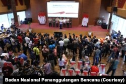 Para jurnalis sedang meliput konferensi pers. (Foto:Badan Nasional Penanggulangan Bencana/BNPB)