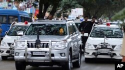 FILE - In this Oct. 18, 2014 file photo, former chief minister of India's Tamil Nadu state Jayaram Jayalalitha travels in a car accompanied by a row of cars with red beacon lights after being released from a prison in Bangalore, India.