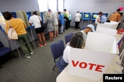 FILE - People cast their ballots in the 2016 general elections at a polling station during early voting in Carrboro, North Carolina, Oct. 20, 2016.