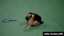 Maria Sharapova, of Russia, reacts after defeating Simona Halep, of Romania, during the first round of the U.S. Open tennis tournament.