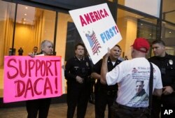 FILE - A supporter of President Donald Trump challenges police officers and a Deferred Action for Childhood Arrivals (DACA) program advocate during a rally outside the office of California Democratic Sen. Dianne Feinstein in Los Angeles, California, Jan. 3, 2018.