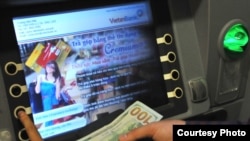 A customer uses a VietinBank cash machine to do a currency exchange transaction. (VietinBank)
