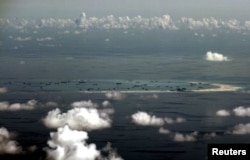 FILE - An aerial photo taken from a Philippine military plane shows reclamation activities by China on Mischief Reef in the Spratly Islands in the South China Sea, west of Palawan, Philippines, May 11, 2015.