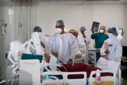 Dr. Kedar Toraskar, tengah, kepala perawatan kritis, memeriksa pasien COVID-19 di bangsal ICU di Rumah Sakit Pusat Wockhardt Mumbai di Mumbai, India, 5 Juni 2021. (Foto: AP)