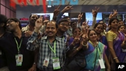 Indian Space Research Organization scientists and other officials celebrate the success of Mars Orbiter Mission at their Telemetry, Tracking and Command Network complex in Bangalore, India, Sept. 24, 2014.