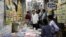 FILE - Students purchase books at a wholesale market in Prayagraj, India, June 20, 2024, as they prepare to study in hopes of landing the security of a government job. 