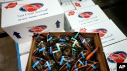 In this Thursday, Dec. 10, 2015, photo, live lobsters are packed for overseas shipment at the Maine Lobster Outlet in York, Maine. (AP Photo/Robert F. Bukaty)