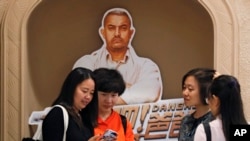 ស្រ្តី​ម្នាក់​មើលរូបថត​នៅ​ក្នុង​ទូរស័ព្ទ​ដៃ​របស់​ខ្លួន​ បន្ទាប់​ពីខ្លួន​និង​មិត្តភក្តិ​ថត​​ជាមួយ​ផ្ទាំង​រូបថត​របស់​តារា Bollywood គឺ​លោក​ Amir Khan នៃ​ខ្សែភាពយន្ត​ដ៏​ល្បី «Dangal» កាល​ពី​ថ្ងៃ​ទី២២ ខែ​ឧសភា​ ឆ្នាំ​២០១៧។