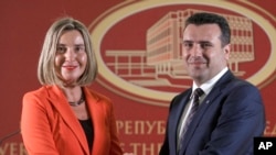 European Union High Representative for Foreign Affairs and Security Policy Federica Mogherini, left, and Macedonian Prime Minister Zoran Zaev pose for a photo, following their meeting at the government building in Skopje, Macedonia, April 18, 2018. 
