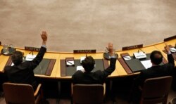 FILE - Members of the U.N. Security Council vote to tighten sanctions on North Korea at U.N. headquarters in New York, March 7, 2013.