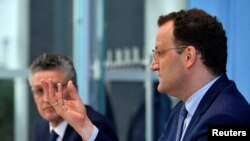 German Health Minister Jens Spahn speaks next to the head of the Robert Koch Institute for disease control Lothar Wieler, during a news conference on the coronavirus situation in Germany, in Berlin, April 17, 2020. 