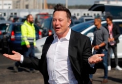 (FILES) In this file photo taken on September 03, 2020, Tesla CEO Elon Musk arrives to visit the construction site of the future US electric car giant Tesla in Gruenheide near Berlin. - Musk says he has tested positive for the novel coronavirus…