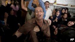Relatives of 15-year-old Ameer al-Nimra, who was killed along with another teenager on Saturday in an Israeli airstrike on Gaza, mourn during his funeral in the family home in Gaza City, July 15, 2018.