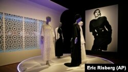 In this photo taken Thursday, Sept. 20, 2018, praying ensembles and dresses are displayed in the exhibit Contemporary Muslim Fashions at the M. H. de Young Memorial Museum in San Francisco. 