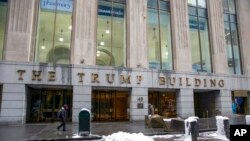 FILE - People walk by The Trump Building office building at 40 Wall Street in New York, Jan. 7, 2022. 