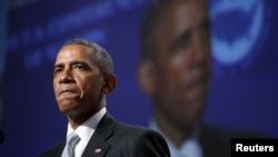U.S. President Barack Obama pauses while speaking about gun violence during an address to the United States Conference of Mayors in San Francisco, June 19, 2015. 