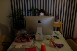 Danielle de Angelis works from home during a lockdown imposed by the state government because of the coronavirus disease (COVID-19) outbreak in Santo Andre, Brazil, March 26, 2020.
