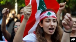 Protester chant slogans during ongoing protests against the Lebanese government, in front of the central bank, in Beirut, Lebanon, Oct. 28, 2019. 