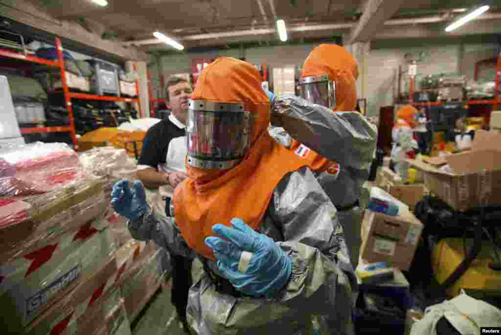 The worst-hit countries - Liberia, Sierra Leone and Guinea - still have far too few Ebola bedspaces - 25 percent of the number needed - and too few firm commitments of help from foreign medical teams, the WHO said.&nbsp; Here, volunteers are taught how to work with patients infected with Ebola before traveling to Africa, near Paris, Oct. 22, 2014. 