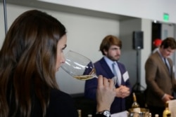 FILE: A woman tastes 2015 vintage wine tasting event January 25, 2018, in San Francisco.