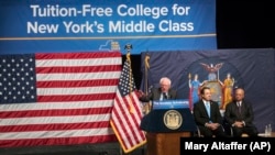 Senator Bernie Sanders, left, is joined by New York Governor Andrew Cuomo, center, and Chairperson of the Board of Trustees of The City University of New York William C. Thompson, as he speaks about a proposal for free tuition at state colleges.